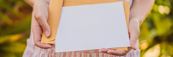 Womens hands in a tropical background holding a signboard paper, mockup BANNER, LONG FORMAT — Stock Photo, Image