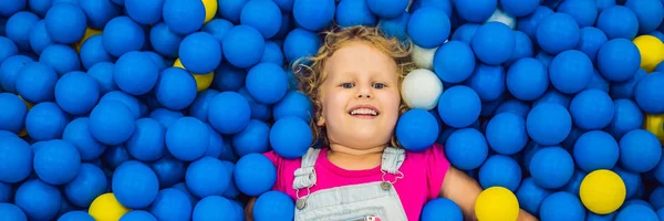 BANNER, LONG FORMAT Anak bermain di lubang bola. Mainan berwarna untuk anak-anak. Taman kanak-kanak atau ruang bermain pra-sekolah. Toddler kid at day care indoor playground. Bola kolam renang untuk anak-anak. Pesta ulang tahun untuk — Stok Foto