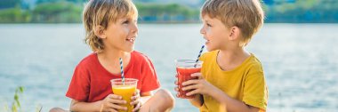Banner, Uzun Format İki erkek palmiye ağaçlarının fon karşı sağlıklı smoothies içmek. Mango ve karpuz smoothies. Çocuklar için sağlıklı beslenme ve vitaminler