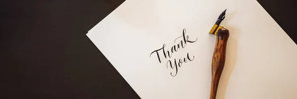 BANNER, LONG FORMAT Thank you. Calligrapher Young Woman writes phrase on white paper. Inscribing ornamental decorated letters. Calligraphy, graphic design, lettering, handwriting, creation concept — Stock Photo, Image