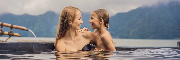 Mamma e figlio viaggiatori a Hot Springs a Bali sullo sfondo del lago. Viaggiare con bambini concetto BANNER, FORMATO LUNGO — Foto Stock