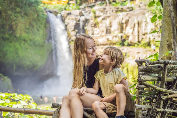 滝を背景にママと息子の観光客。子供のコンセプトで旅行。子供たちと一緒に何をすべきか 子供に優しい場所 — ストック写真