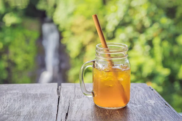 Iced tea on the background of waterfalls — Stock Photo, Image