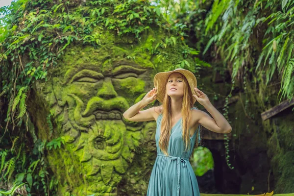 Young woman traveler in a Balinese garden overgrown with moss. Travel to Bali concept — Stock Photo, Image