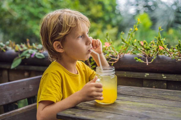 Boy drinking juice in a cafe. What to do with children. Child friendly place — Stock Photo, Image