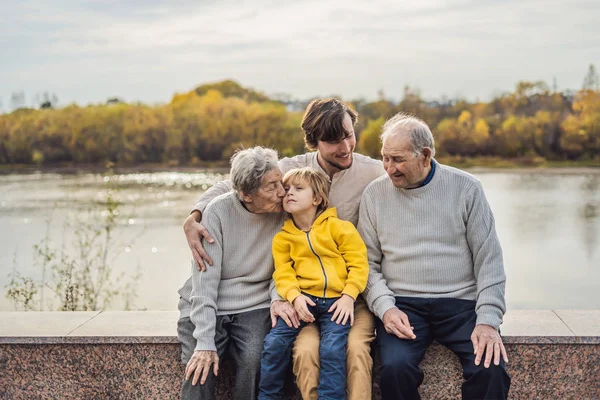 Старшая пара с внуком и правнуком в осеннем парке. Прабабушка, прадедушка и правнук — стоковое фото