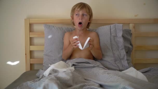 Superslowmotion strzał chorych małego chłopca w łóżku. Koncepcja grypa dziecka — Wideo stockowe