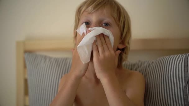 Tiro em câmara lenta de um rapazinho doente numa cama. Conceito de gripe infantil — Vídeo de Stock