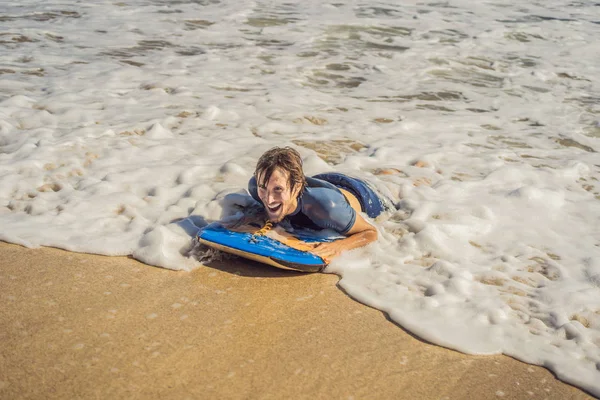 Young Man with Boogie Board at the Beach