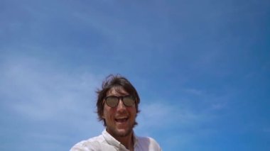 Mutlu bir turist Superslowmotion çekim onun üzerinde uçan bir uçak ile tropikal bir plajda eğlenin