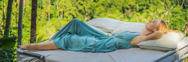 Mladá žena v posteli v džungli. Intimita s přírodou nápis, dlouhý formát — Stock fotografie