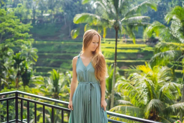 Beautiful young woman walk at typical Asian hillside with rice farming, mountain shape green cascade rice field terraces paddies. Ubud, Bali, Indonesia. Bali travel concept — Stock Photo, Image