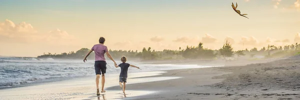 Giovane padre e suo figlio in esecuzione con aquilone sulla spiaggia BANNER, FORMATO LUNGO — Foto Stock