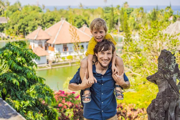 Dad and son in Water Palace Soekasada Taman Ujung Ruins on Bali Island in Indonesia. Amazing old architecture. Travel and holidays background. Traveling with kids concept. Kids Friendly places — Stock Photo, Image