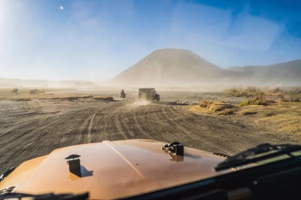 View from inside of an offroad car riding through the so-called Sea of sand inside the Tengger caldera at the Bromo Tengger Semeru National Park in the Java Island, Indonesia. One of the most famous — Stock Photo, Image