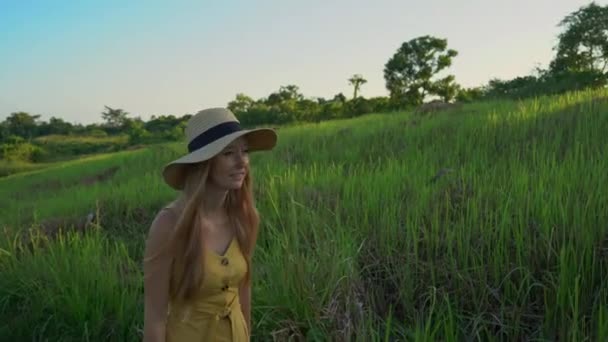 Una giovane donna con un vestito giallo che cammina al Campuhan Ridge Walk o pittori passerella a Ubud. Destinazioni di viaggio a Bali. Viaggiare a Bali concetto . — Video Stock