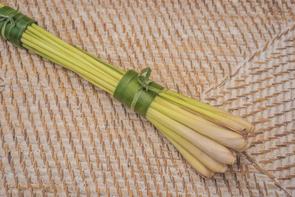 Eco-friendly product packaging concept. Lemongrass wrapped in a banana leaf, as an alternative to a plastic bag. Zero waste concept. Alternative packaging