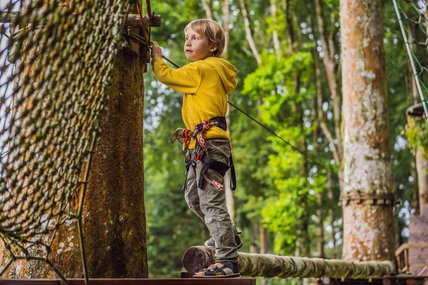 Little boy in a rope park. Active physical recreation of the child in the fresh air in the park. Training for children — Stock Photo, Image