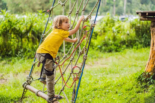 Little boy in a rope park. Active physical recreation of the child in the fresh air in the park. Training for children — Stock Photo, Image