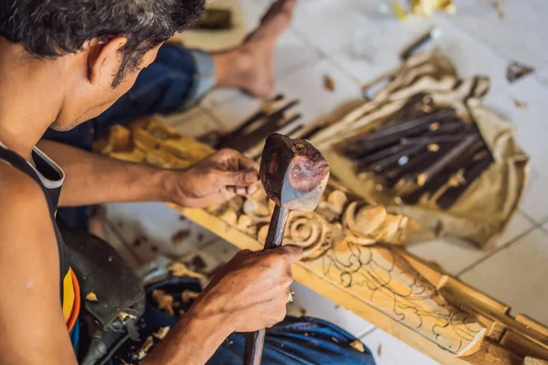 Holzschnitzermeister, der ein spezielles hölzernes Nationalgericht verwendet - eine Schöpfkelle mit gemustertem Griff. Fragment einer Nahaufnahme seiner Hände — Stockfoto