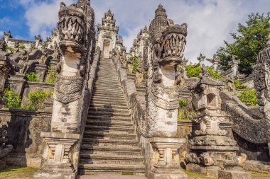 Three stone ladders in beautiful Pura Lempuyang Luhur temple. Summer landscape with stairs to temple. Paduraksa portals marking entrance to middle sanctum jaba tengah of Pura Penataran Agung, Bali clipart