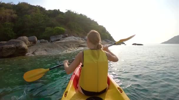 Fotografía en cámara lenta de una joven familia haciendo kayak en un mar tropical y divirtiéndose mirando arrecifes de coral y peces tropicales bajo el agua. Playa de Ya Nui en la isla de Phuket — Vídeo de stock