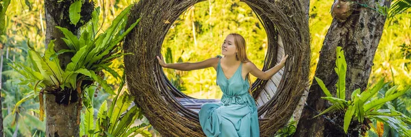 Bali trend, straw nests everywhere. Young tourist enjoying her travel around Bali island, Indonesia. Making a stop on a beautiful hill. Photo in a straw nest, natural environment. Lifestyle BANNER