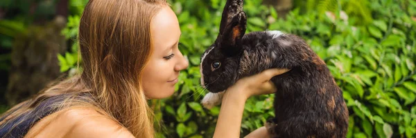 ウサギを抱いた女ウサギ動物の化粧品試験。残酷な自由と停止動物虐待コンセプトバナー、ロングフォーマット — ストック写真