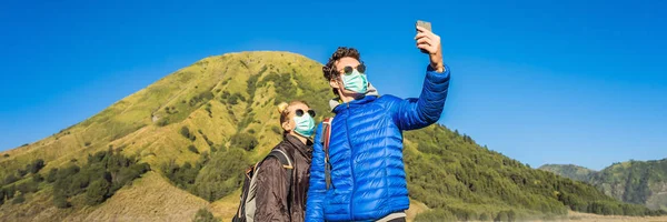 BANNER, FORMATO LARGO Turistas jóvenes hacen una selfie en el Parque Nacional Bromo Tengger Semeru en la Isla Java, Indonesia. Disfrutan de magníficas vistas sobre el Bromo o Gunung Bromo en — Foto de Stock