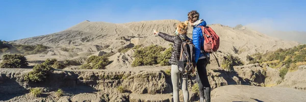 BANNER, LONG FORMAT Jovens casais visitam o vulcão Bromo no Parque Nacional Tengger Semeru, em Java Island, Indonésia. Eles apreciam a vista magnífica sobre o Bromo ou Gunung Bromo em — Fotografia de Stock