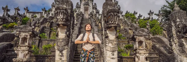 Young man tourist on background ofThree stone ladders in beautiful Pura Lempuyang Luhur temple. Summer landscape with stairs to temple. Paduraksa portals marking entrance to middle sanctum jaba tengah — Stock Photo, Image