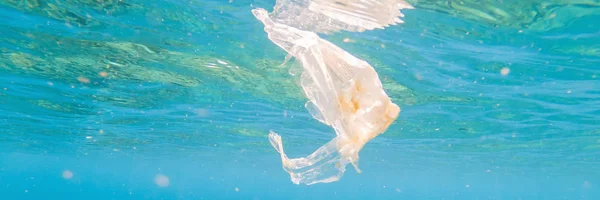 Plastic ocean. Pollution crisis as plastic bags, cups, straws and bottles end up in sea BANNER, LONG FORMAT