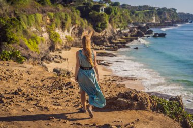Young woman tourist on Pantai Tegal Wangi Beach, Bali Island, Indonesia. Bali Travel Concept clipart