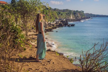 Young woman tourist on Pantai Tegal Wangi Beach, Bali Island, Indonesia. Bali Travel Concept clipart