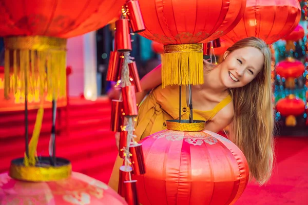 Woman celebrate Chinese New Year look at Chinese red lanterns. Chinese lanterns