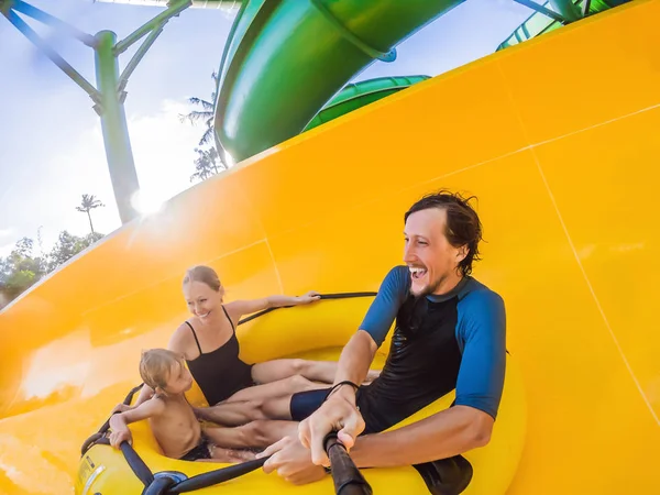 Mom, dad and son at the water park eating along the roller coaster — Stock Photo, Image