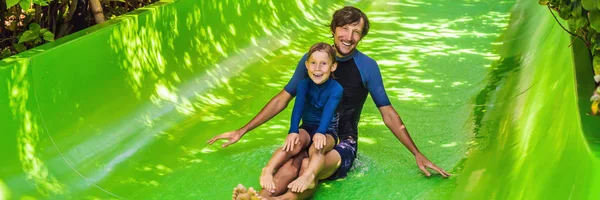 Dad and son have fun at the water park BANNER, LONG FORMAT