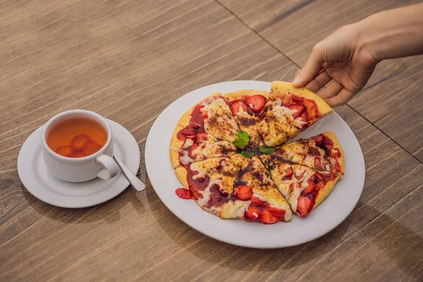 Kvinne som spiser deilig jordbærpizza med balinesisk tropisk bakgrunn. Bali, Indonesia – stockfoto