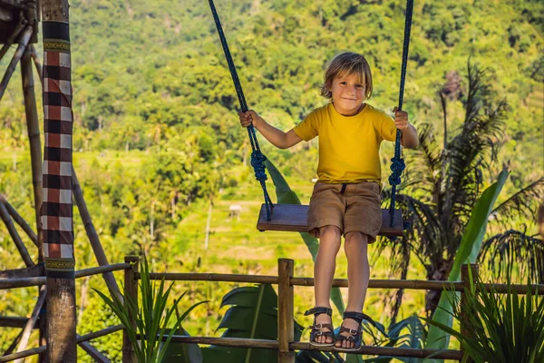 Niño balanceándose en la selva tropical de la isla de Bali, Indonesia. Balancéate en los trópicos. Las oscilaciones - la tendencia de Bali. Viajar con concepto de niños. Qué hacer con los niños. Lugar adecuado para niños — Foto de Stock