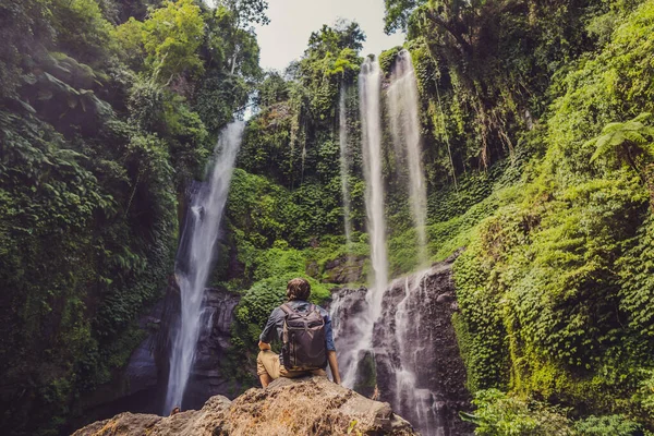 Man in turquoise dress at the Sekumpul waterfalls in jungles on Bali island, Indonesia. 발리 여행의 개념 — 스톡 사진