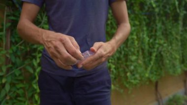 Birisi veri kablosu olan bir kutuyu açıyor ve ne kadar plastiğin çöpe atılacağını gösteriyor. Fazla plastik ambalaj kavramı. Plastik atık kavramını küçült