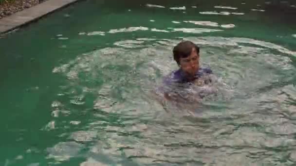 A fiatalember egy medencében edzi a harci technikáját. Harci képzés a medence koncepciójában — Stock videók