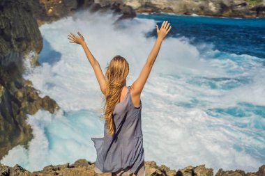 Nusa Penida, Bali, Endonezya 'da Melek Billabong denizinin arka planına karşı bir kadın gezgin. Bali Seyahat Konsepti