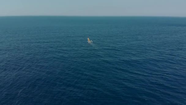 Aerial shot of the traditional fishing sailing boats in an open sea close to Bali island — Stock Video