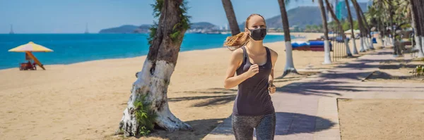 BANNER, LONG FORMAT Woman runner wearing medical mask. Running in the park. Coronavirus pandemic Covid-19. Sport, Active life in quarantine surgical sterilizing face mask protection. Outdoor run on