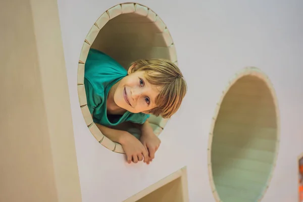 The boy has fun in an indoor playground — Stock Photo, Image