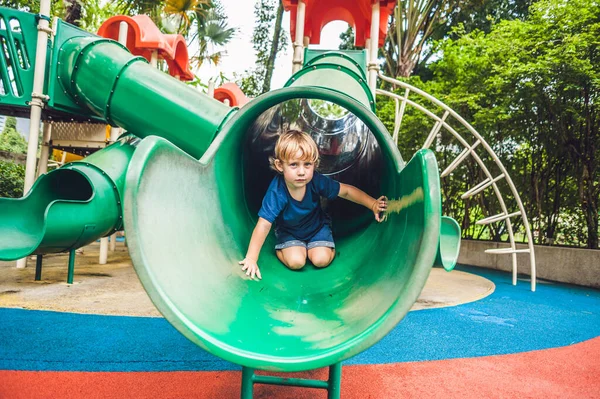 Renkli çocuk parkında oynayan küçük mutlu çocuk. Sevimli çocuk dışarıda eğleniyor. — Stok fotoğraf