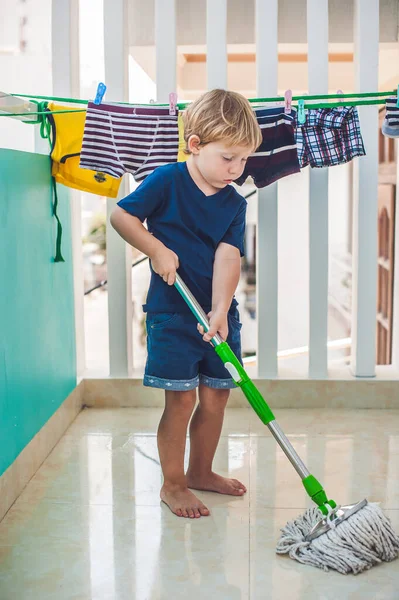 Kid boy cleaning room, washing floor with mop. Little home helper — Stock Photo, Image