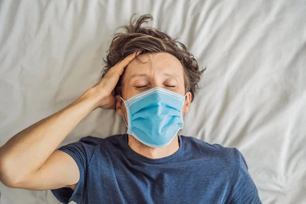 Extremly tired young man lying on the bed, home alone. self-isolation at home, quarantine due to pandemic COVID 19. Mental health problems in self-isolation at home — Stock Photo, Image