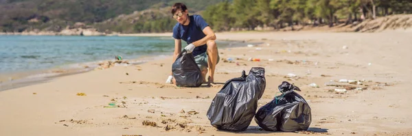 Man in gloves pick up plastic bags that pollute sea. Problem of spilled rubbish trash garbage on the beach sand caused by man-made pollution and environmental, campaign to clean volunteer in concept